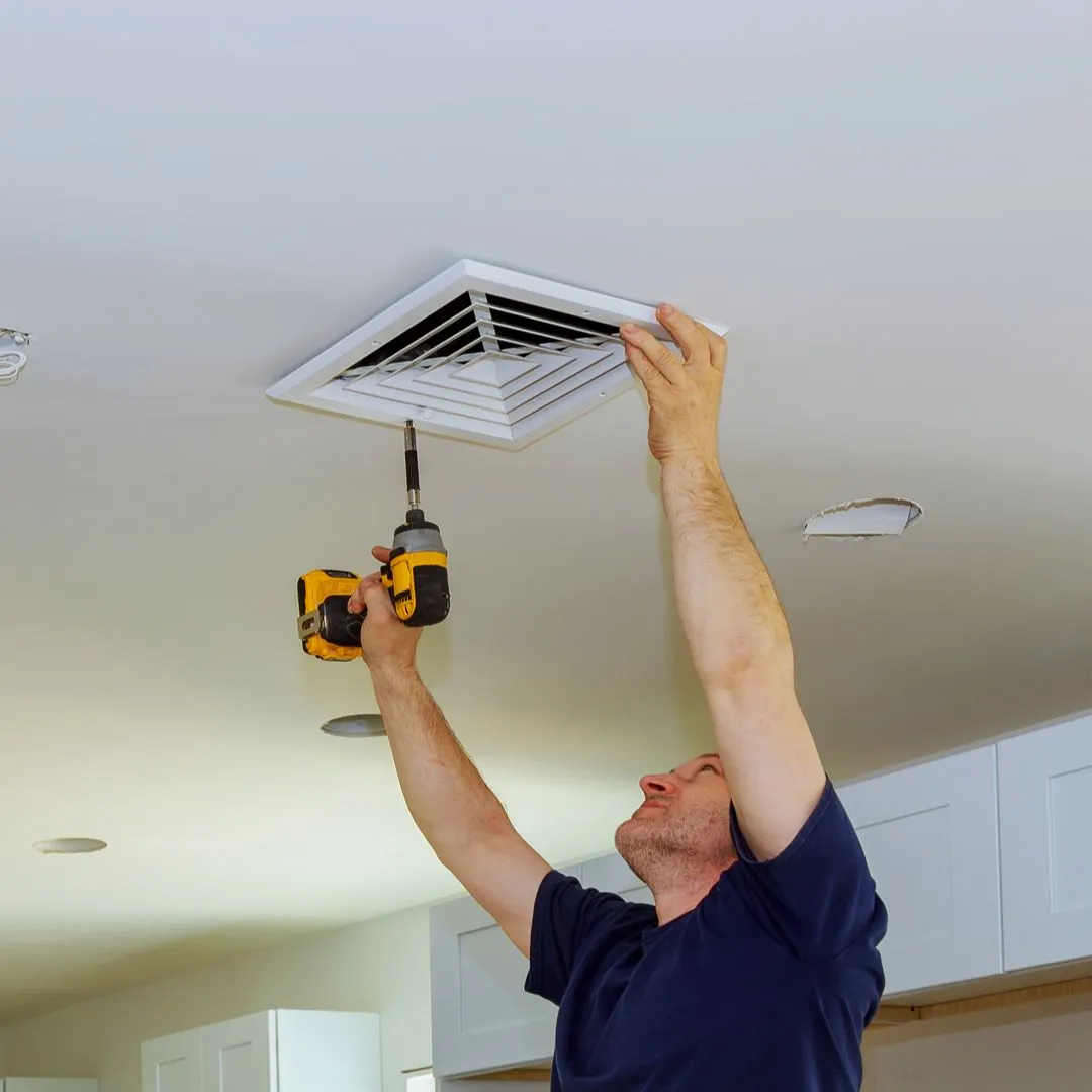 Flavin Home Services - Handy man fixing air conditioner